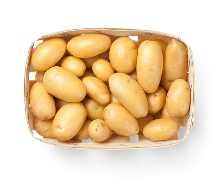 Raw potatoes in basket isolated on white background. Top viewの写真素材