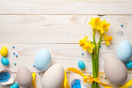 Easter background with easter eggs and spring flowers. Top view with copy spaceの写真素材