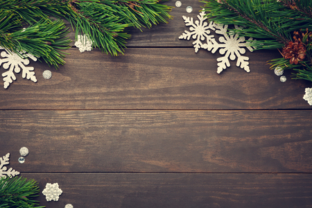 Christmas composition with silver snowflakes on wooden background. Copy space. Top viewの写真素材