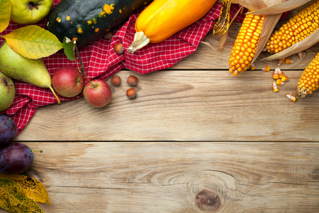 Autumn vegetables and fruits on wooden table. Top view. Copy spaceの写真素材