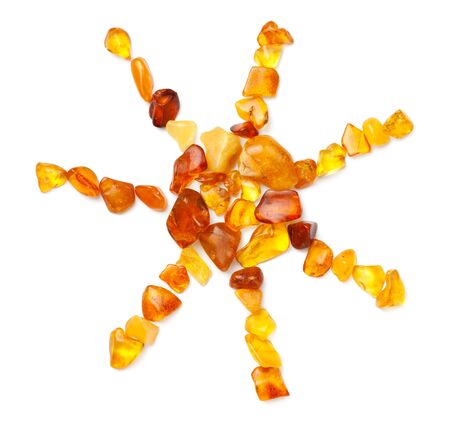 Sun made of ambers isolated on white background. Pieces of polished amber. Top view, flat layの写真素材