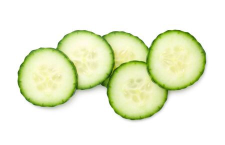 Cucumber slices isolated on white background. Light shadow. Top view, flat layの写真素材