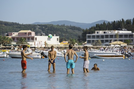 CORFU, GREECE - AUGUST 19, 2016: Young people at Sidari beach playing with ball in waterのeditorial素材
