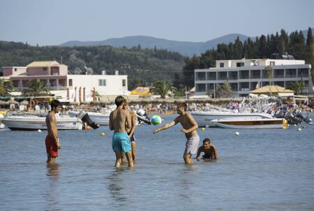 CORFU, GREECE - AUGUST 19, 2016: Young people at Sidari beach playing with ball in waterのeditorial素材
