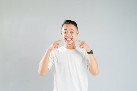 a young asian showing a big smileの写真素材