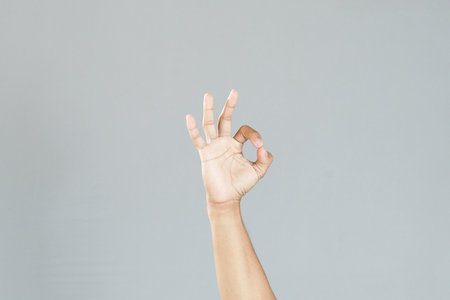 hand ok sign on grey backgroundの写真素材