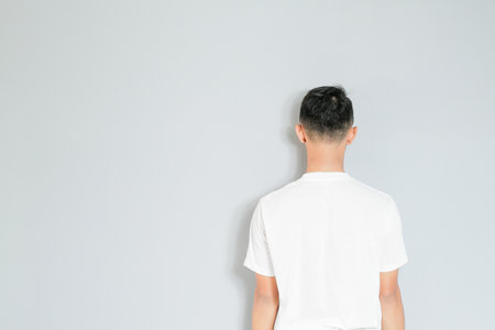 an Asian youth is facing backwardsの写真素材