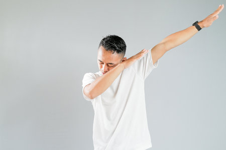 an asian youth showing a ridiculous expressionの写真素材