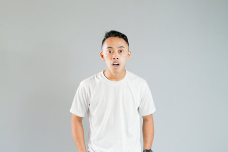 an Asian youth was being shockedの写真素材