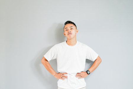 an asian youth showing a ridiculous expressionの写真素材