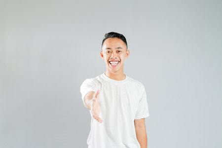a young asian man offers a handshakeの写真素材
