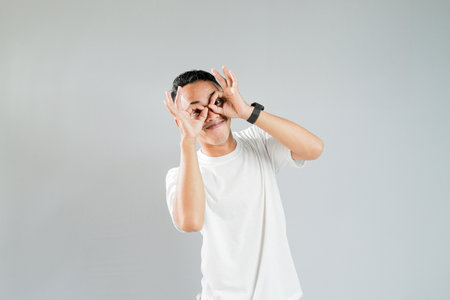 an asian youth showing a ridiculous expressionの写真素材