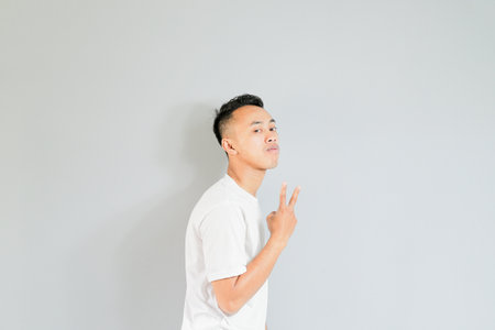 an asian youth showing a ridiculous expressionの写真素材