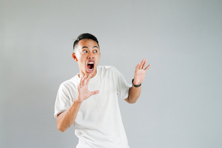 a young asian was showing a shocked expressionの写真素材