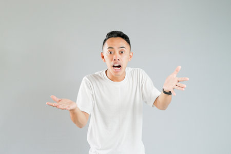 a young asian is showing an expression of not knowingの写真素材