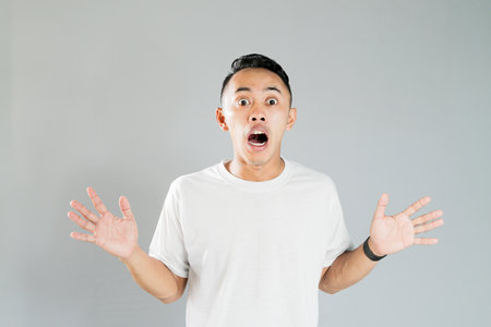 a young asian was showing a shocked expressionの写真素材