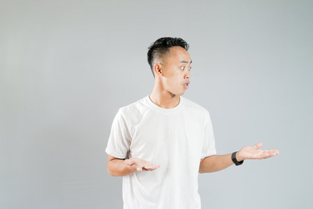 a young asian is showing an expression of not knowingの写真素材
