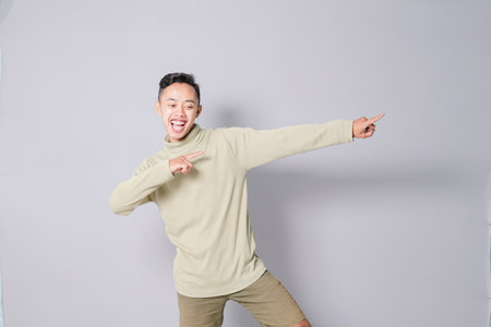 Asian youth is having euphoria, isolated on gray backgroundの写真素材