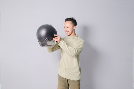 young asian man wearing helmet, isolated on gray backgroundの写真素材