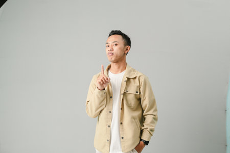 an Asian youth is making a silent gestureの写真素材