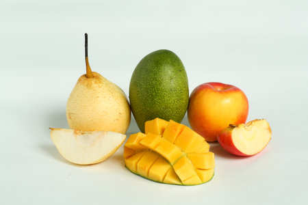pears, red apple's and mango  placed on a plain white baseの写真素材