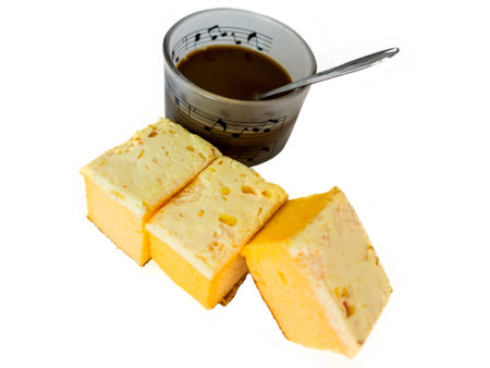 coffee and sliced butter cake on white backgroundの写真素材