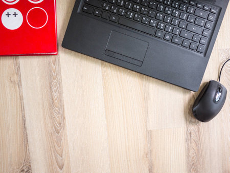 Office, laptop and red notebook on the table on working dayの写真素材