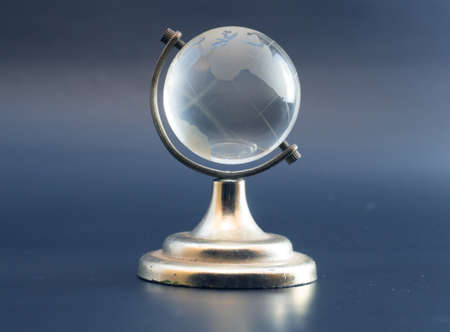 White crystal transparent Globe or globus isolated ball which standing on metal golden frame with...