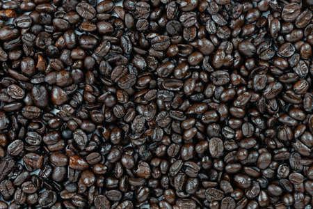 dark roasted arabica coffee beans background and texture close up short on top view full frame