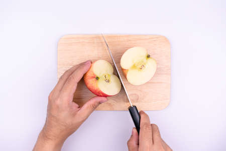 chef cutting apple before cooking concept on a cutting board isolated on a white background, Sweet...