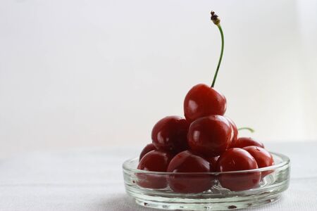 Cherries with glass dishの写真素材