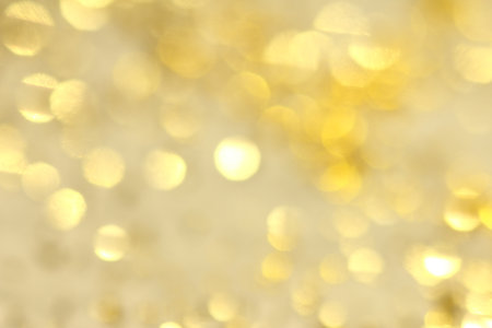 Abstract background with golden glittery bokeh.の写真素材