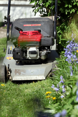 A mower with boots and a rakeの写真素材