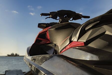 Small motorized watercraft parked at marina. Blue sky and sea.の写真素材