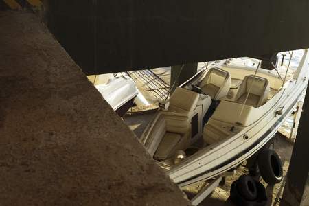 Old and dirty boat left behind by owner in marina. Abandoned.の写真素材