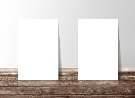 Two blank white paper template banners on the wooden floor against the wallの写真素材