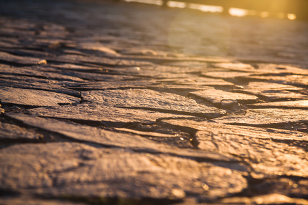 Close up view on the road pavement bricks. Old cobblestone walkway.の写真素材
