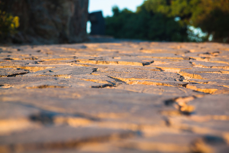 Close up view on the road pavement bricks. Old cobblestone walkway.の写真素材