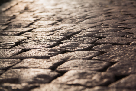 Close up view on the road pavement bricks. Old cobblestone walkway.の写真素材