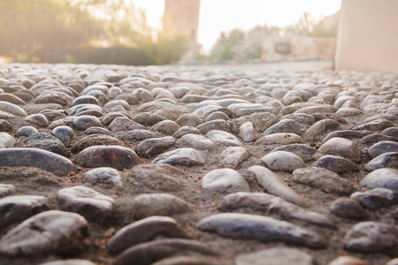 Close up view on the road pavement bricks. Old cobblestone walkway.の写真素材