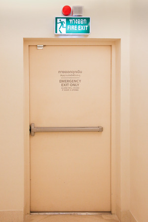 Building Emergency Exit with Exit Sign and Fire Extinguisher.の写真素材