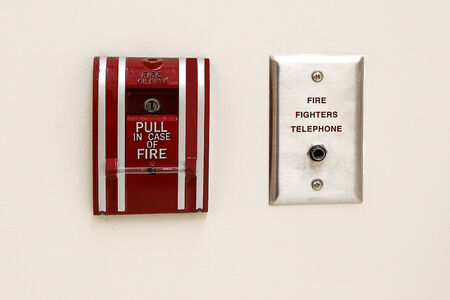 Red fire alarm on white background