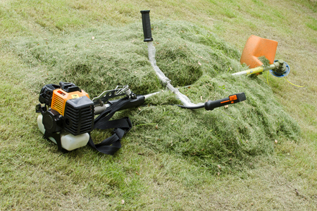 brush cutter puts on the haystack at noon during lunch break at high temperature