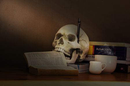 The skull is still concerned about education, even though he has died and still intends to learn. still life with copy spaces.の写真素材