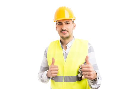 Smiling confident handsome constructor showing double like or thumbs-up gesture isolated on white...