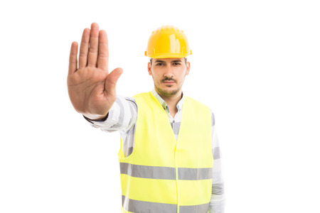 Engineer or architect showing palm as stop stay gesture or refusal denial sign isolated on white...