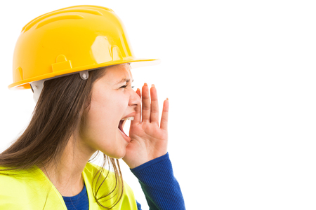 Young woman architect or engineer screaming with hand on mouth as angry yelling manager concept isolated on white backgroundの写真素材