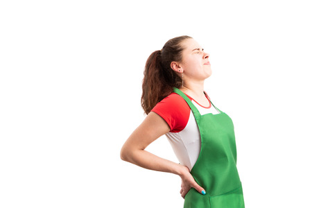 YoungÂ female supermarket or hypermarket worker suffering back lumbar pain as exhausted tired...