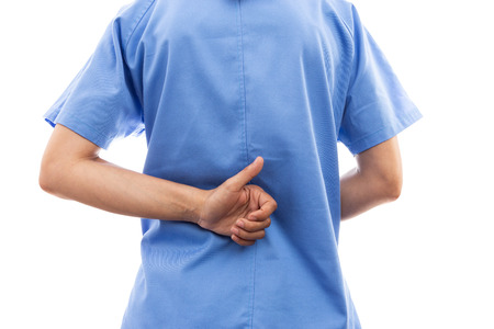 Rear view of female nurse or doctor back making thumbs up gesture from behind as good health care...