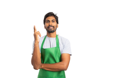Smiling seller or hypermarket indian employee making great idea gesture with fingers in the air as inspiration concept isolated on white with blank copyspaceの写真素材